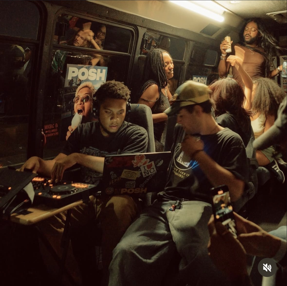 DJs playing inside a bus with Posh signs in the windows
